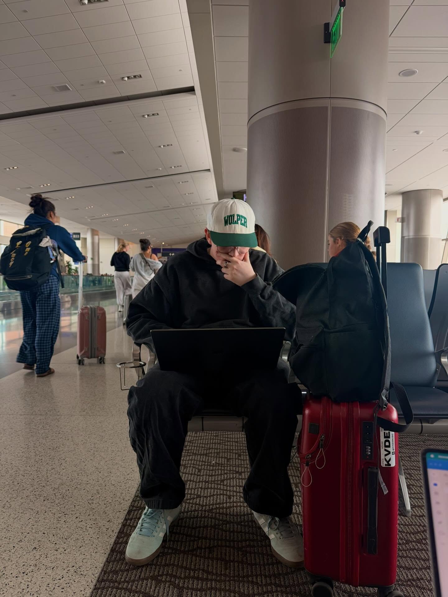 Kaden Meza working on a laptop at the airport